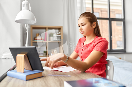 Image of student girl with tablet pc learning at home