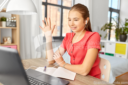 Image of student girl with laptop having video call at home