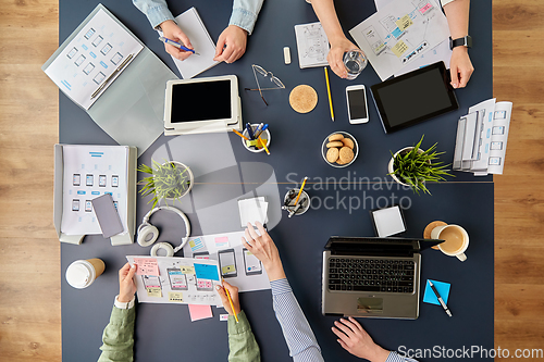 Image of business team with gadgets working at office table