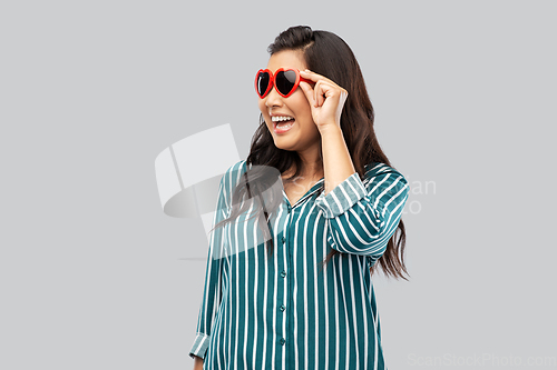 Image of happy asian woman with in heart shaped sunglasses