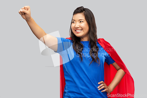 Image of happy asian woman in red superhero cape