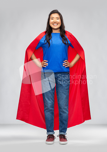 Image of happy asian woman in red superhero cape