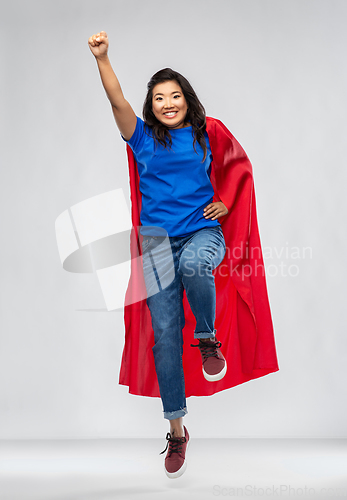 Image of happy asian woman in red superhero cape