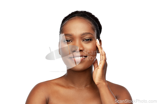 Image of portrait of african woman touching her face