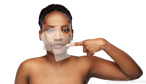 Image of african american woman pointing to her mouth