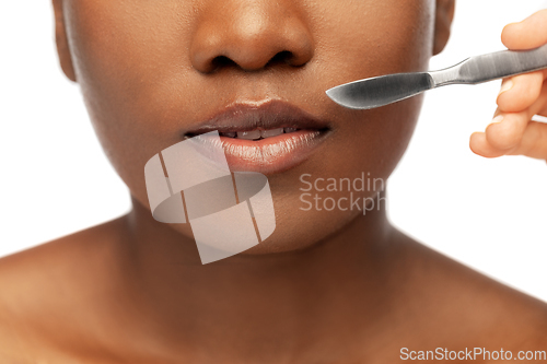 Image of face of african american woman and scalpel knife