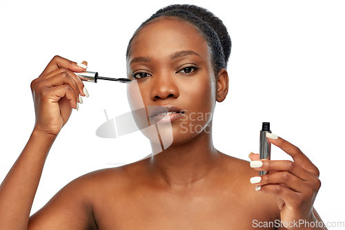 Image of beautiful african american woman applying mascara