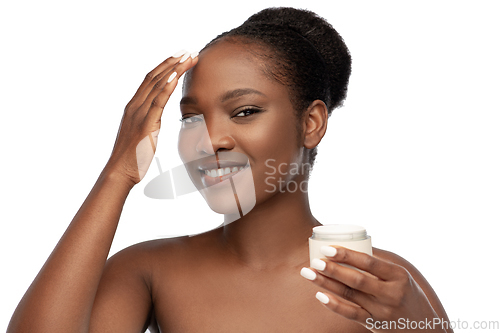 Image of smiling african american woman with moisturizer