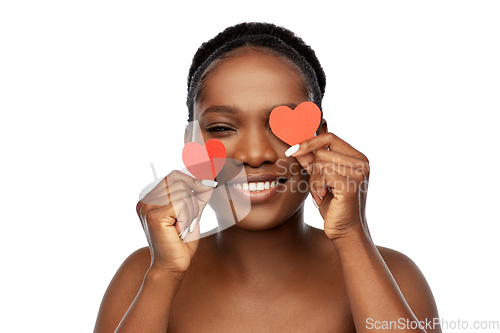 Image of smiling african american woman with red hearts