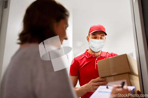 Image of delivery man in mask with parcel and customer