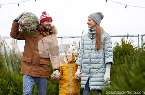 Image of happy family buying christmas tree at market