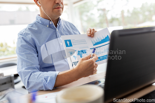 Image of man working and having video call at home