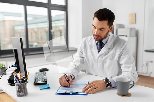 Image of male doctor with clipboard at hospital