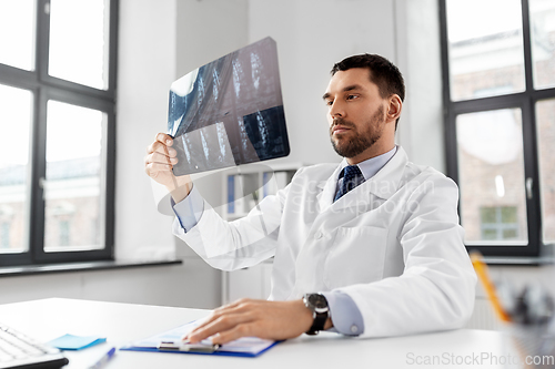 Image of male doctor with x-ray of spine at hospital