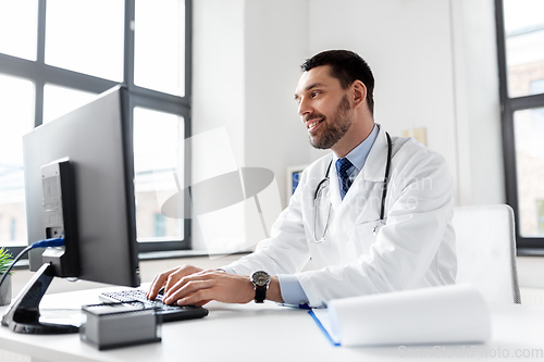 Image of male doctor with computer working at hospital