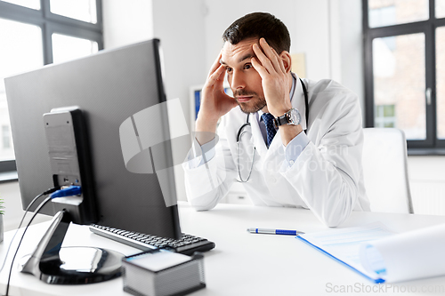 Image of male doctor with computer working at hospital
