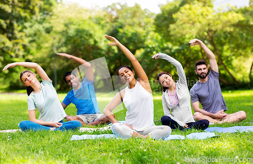 Image of group of people exercising at summer park