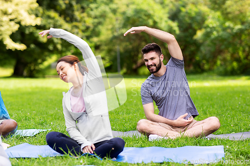 Image of group of people exercising at summer park