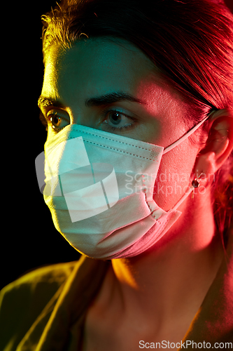 Image of young woman wearing protective medical mask