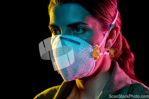 Image of young woman wearing protective mask or respirator