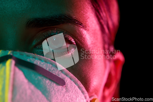 Image of young woman wearing protective mask or respirator