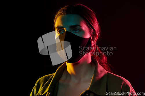 Image of young woman wearing reusable protective mask