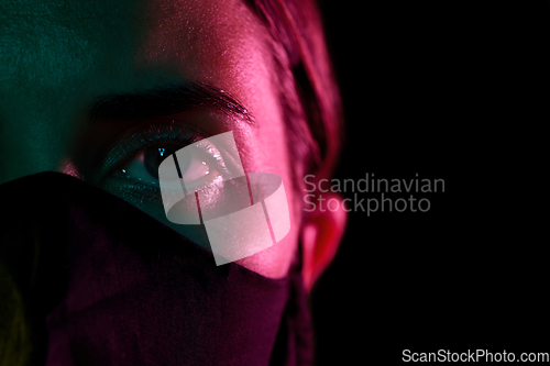 Image of young woman wearing reusable protective mask