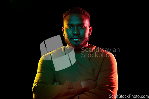 Image of young african american man over black background