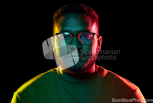 Image of young african american man in glasses over black