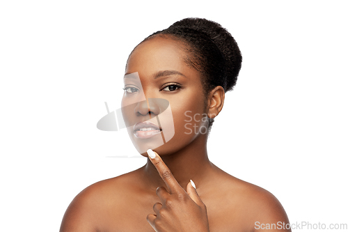 Image of portrait of african woman touching her face