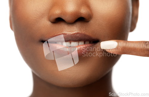 Image of african american woman pointing to her mouth