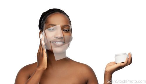 Image of smiling african american woman with moisturizer