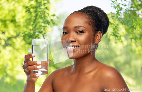 Image of young african american woman with glass of water