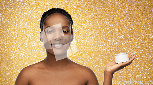 Image of smiling african american woman with moisturizer