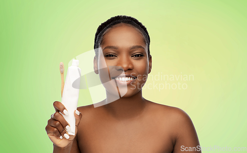 Image of african woman with toothbrush and toothpaste