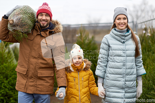 Image of happy family buying christmas tree at market