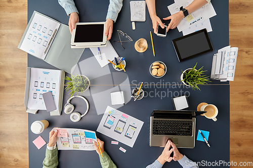 Image of business team with gadgets working at office table