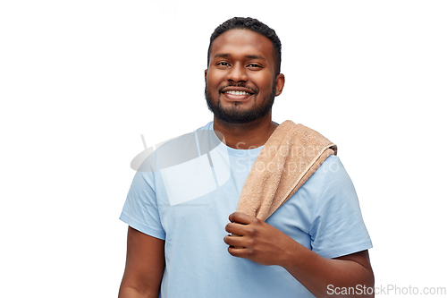 Image of smiling african american young man with bath towel