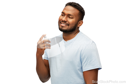 Image of happy african american man with perfume