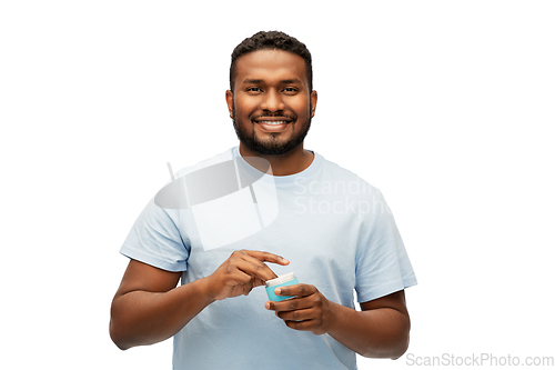 Image of happy african american man with moisturizer