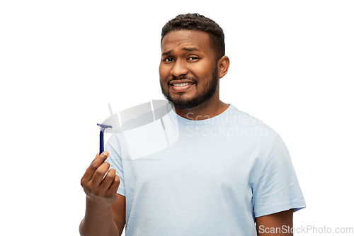 Image of african american man holding razor blade