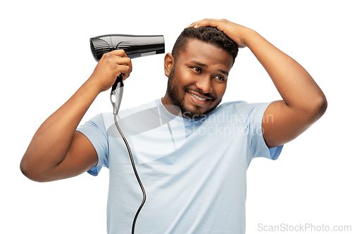 Image of african american man with fan or hair dryer