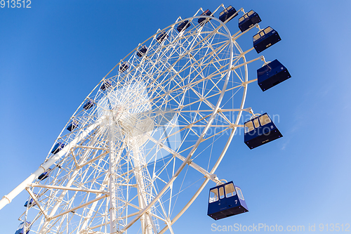 Image of Ferris wheel with blue sky