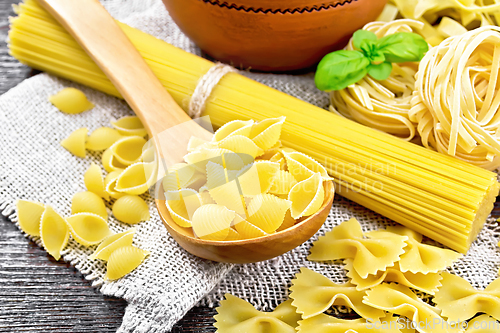 Image of Pasta different with basil on black board