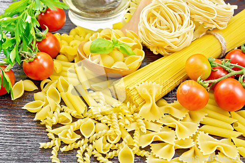 Image of Pasta different with oil and tomatoes on table