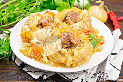 Image of Pasta with meatballs in plate on dark board