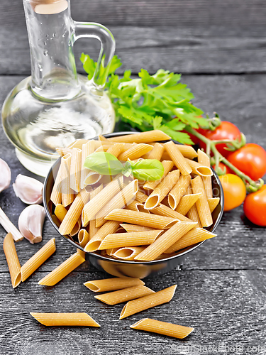 Image of Penne whole grain in bowl with vegetables on table