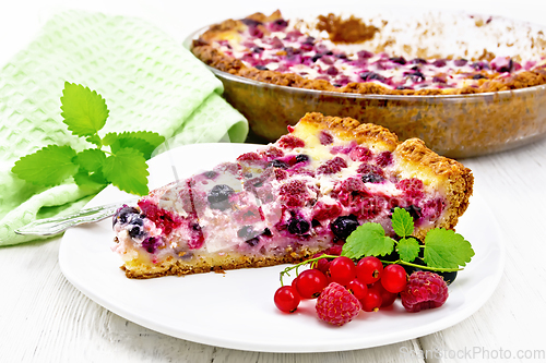 Image of Pie with raspberries and currants in plate on board