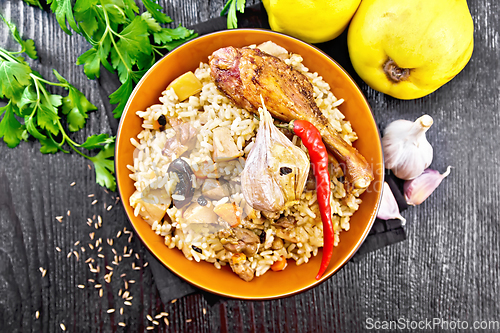 Image of Pilaf with duck and quince in plate on board top