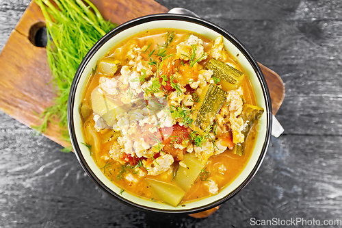 Image of Ragout of zucchini and minced meat in bowl on board top